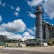 Industrial power plant with large smokestack and pipes