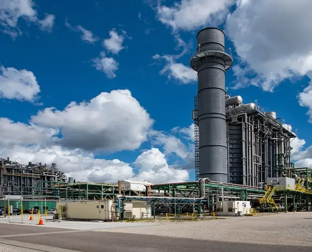 Industrial power plant with large smokestack and pipes