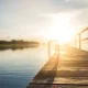 Sunset over wooden dock on calm lake