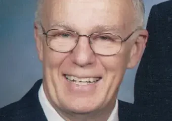 Smiling older man in suit and glasses