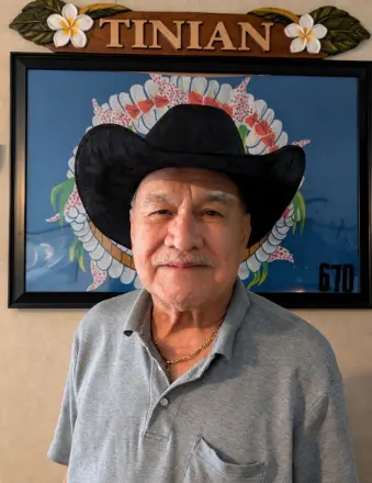 Older man in cowboy hat indoors