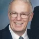 Smiling older man in suit and glasses