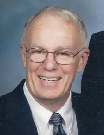 Smiling older man in suit and glasses