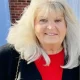 Smiling older woman with blonde hair outdoors