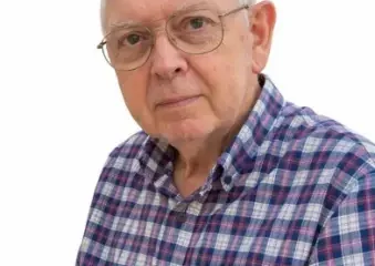 Older man wearing glasses and plaid shirt