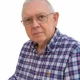Older man wearing glasses and plaid shirt