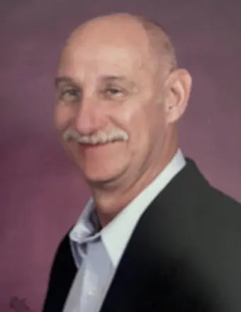Smiling bald man with mustache in blazer