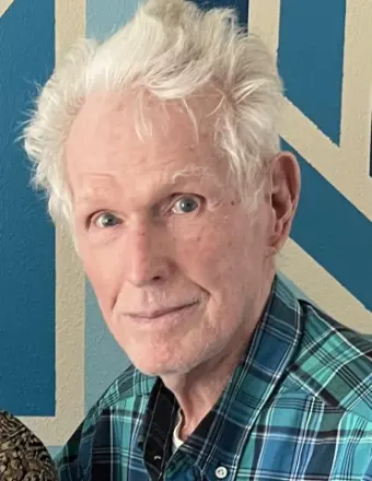 Elderly man with white hair and plaid shirt