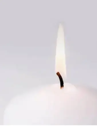 Close-up of a lit white candle flame
