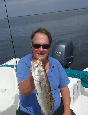 Man holding large fish on boat