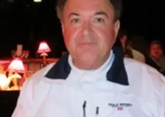 Man in white jacket at dim restaurant