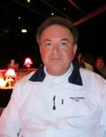 Man in white jacket at dim restaurant