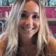 Smiling woman with sunglasses in colorful cafe