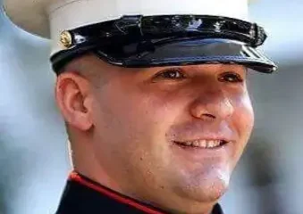 Smiling U.S. Marine in dress uniform cap