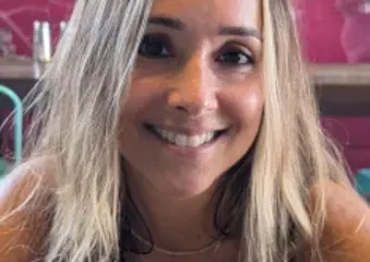 Smiling woman with blonde hair in colorful cafe
