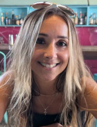 Smiling woman with blonde hair in colorful cafe