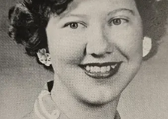 Black-and-white portrait of smiling young woman