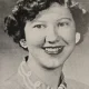 Black-and-white portrait of smiling young woman