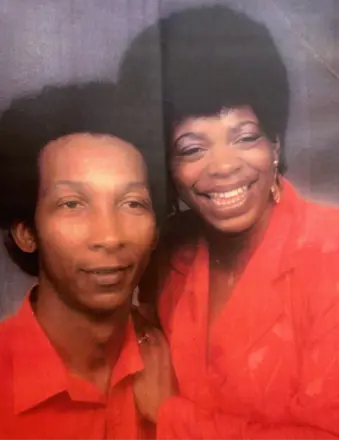Two people in red outfits smiling together