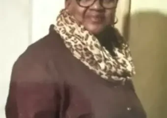 Woman wearing glasses and leopard print scarf indoors