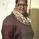 Woman wearing glasses and leopard print scarf indoors