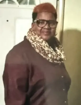 Woman wearing glasses and leopard print scarf indoors