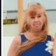 Woman in blue dress by waterfront dock
