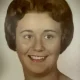 Vintage portrait of smiling woman with short brown hair
