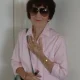 Elderly woman in sunglasses and pink shirt