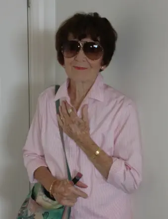 Elderly woman in sunglasses and pink shirt