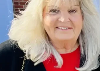 Smiling older woman with blonde hair outdoors