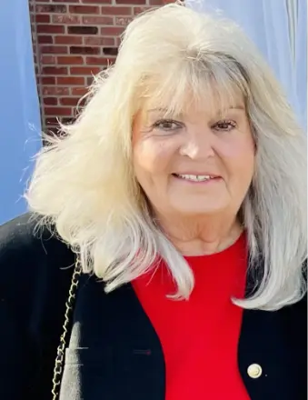 Smiling older woman with blonde hair outdoors