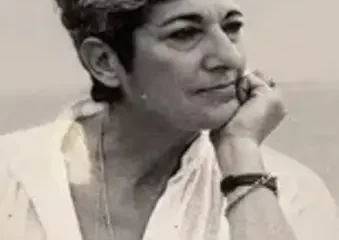 Black-and-white portrait of contemplative woman resting chin on hand