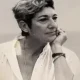 Black-and-white portrait of contemplative woman resting chin on hand
