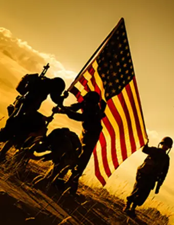 Soldiers raising American flag at sunset silhouette