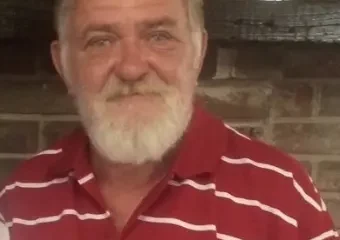 Older man with white beard in red striped shirt