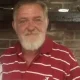 Older man with white beard in red striped shirt
