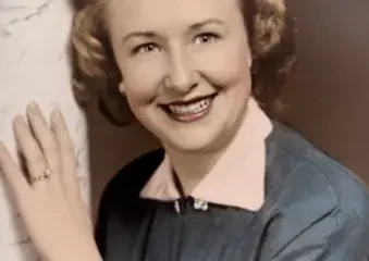 Smiling woman in vintage portrait beside marble column