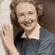 Smiling woman in vintage portrait beside marble column