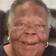 Smiling elderly woman with short gray hair