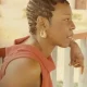 Woman with braided hair leaning on railing
