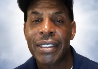 Man wearing baseball cap against neutral background
