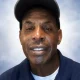 Man wearing baseball cap against neutral background