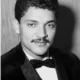 Black-and-white portrait of man in tuxedo