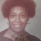 Smiling woman with short afro and scarf