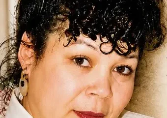Close-up portrait of woman with curly dark hair