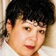 Close-up portrait of woman with curly dark hair