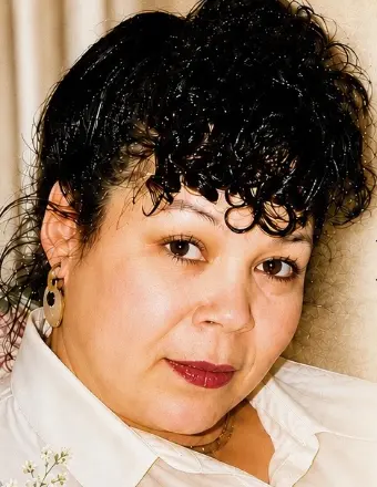 Close-up portrait of woman with curly dark hair