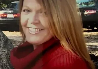 Smiling woman in red sweater outdoors