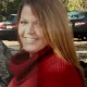 Smiling woman in red sweater outdoors